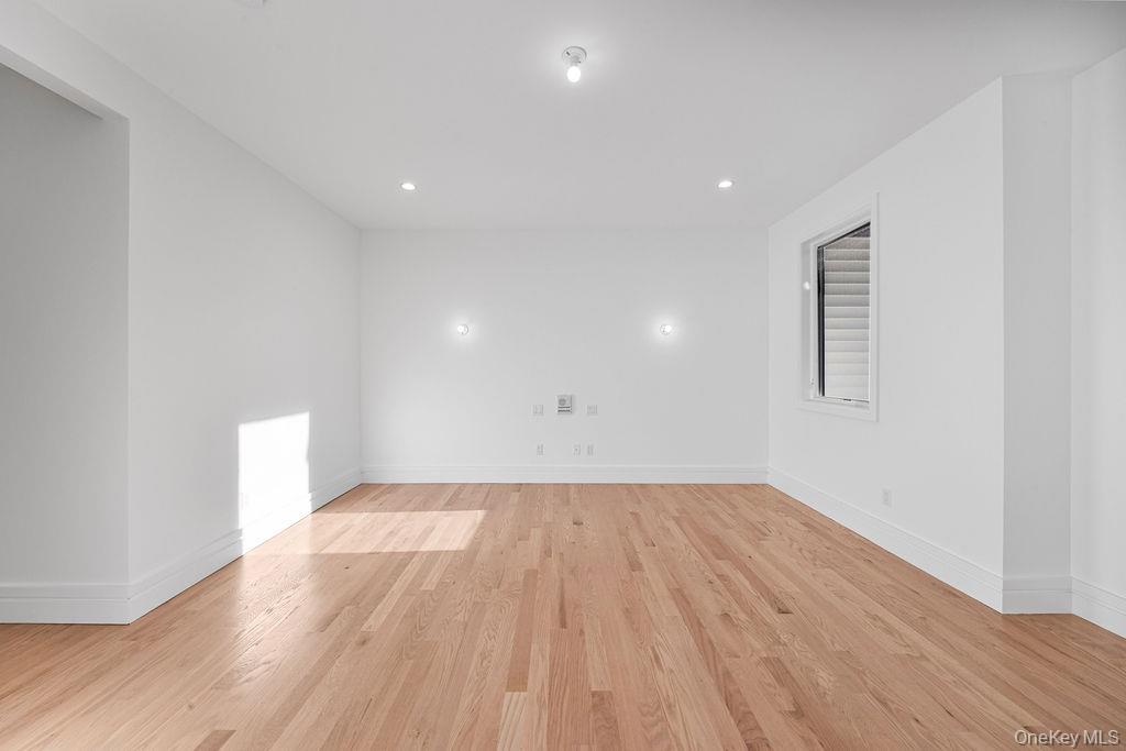40 Singer Avenue, Unit 201 Spring Valley, NY 10977 - Photo 21 of 50 a view of an empty room with wooden floor and a window