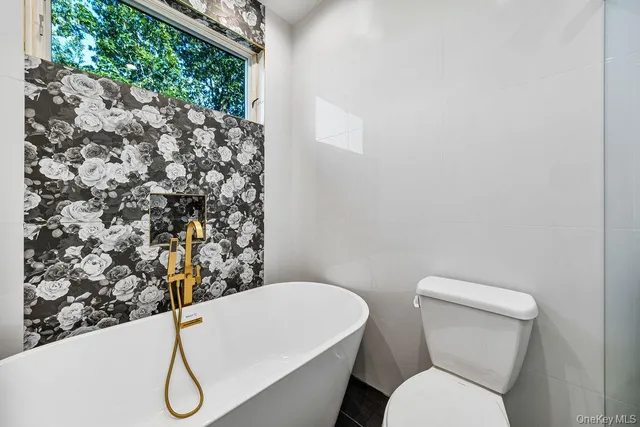 a white toilet sitting next to a shower curtain