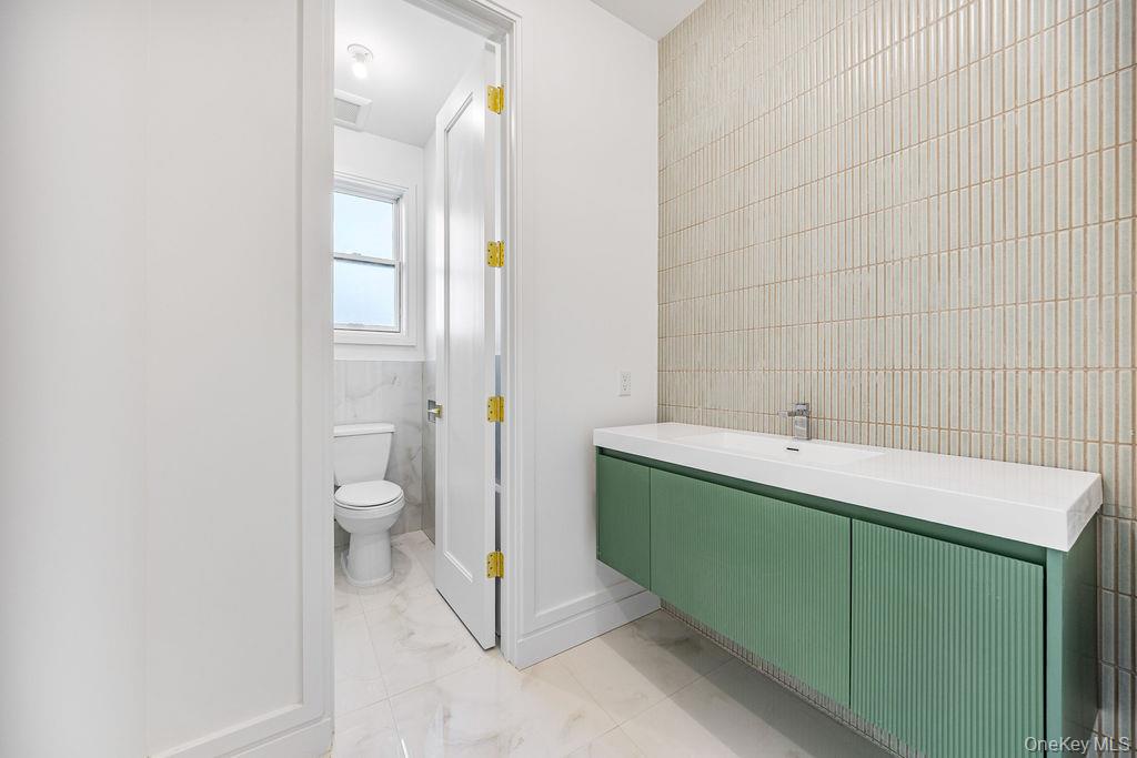 40 Singer Avenue, Unit 201 Spring Valley, NY 10977 - Photo 30 of 50 a bathroom with a sink and a toilet