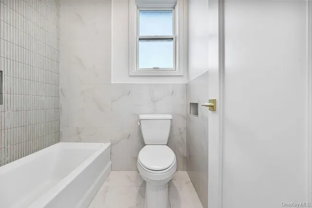 a bathroom with a toilet and a sink