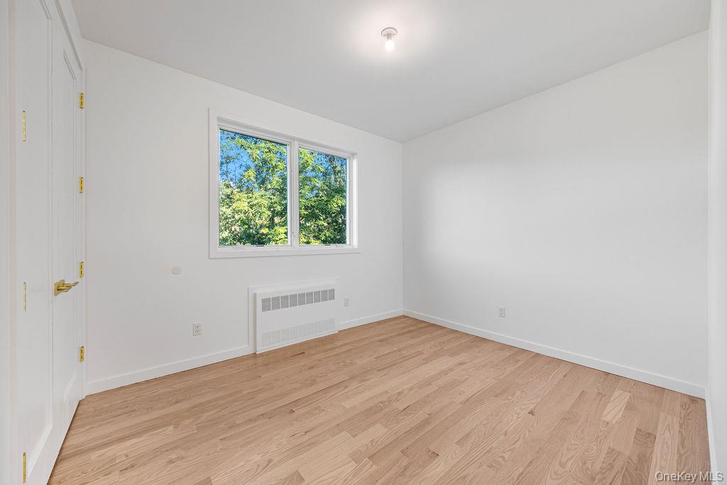 40 Singer Avenue, Unit 201 Spring Valley, NY 10977 - Photo 32 of 50 wooden floor in an empty room with a window