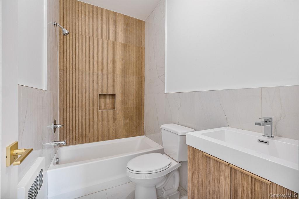 40 Singer Avenue, Unit 201 Spring Valley, NY 10977 - Photo 35 of 50 a bathroom with a sink a toilet and shower