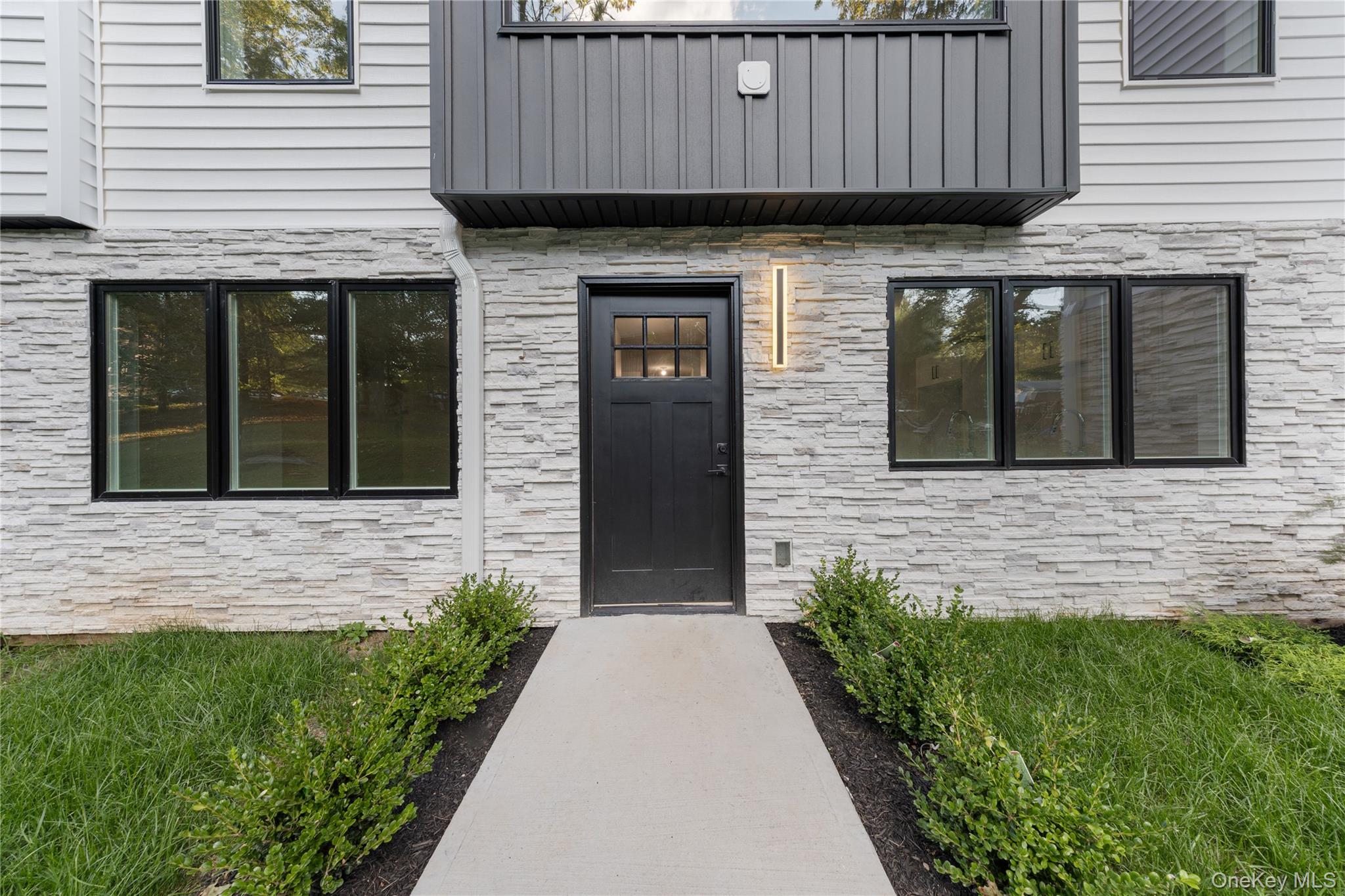 40 Singer Avenue, Unit 201 Spring Valley, NY 10977 - Photo 39 of 50 a front view of a house with a garden