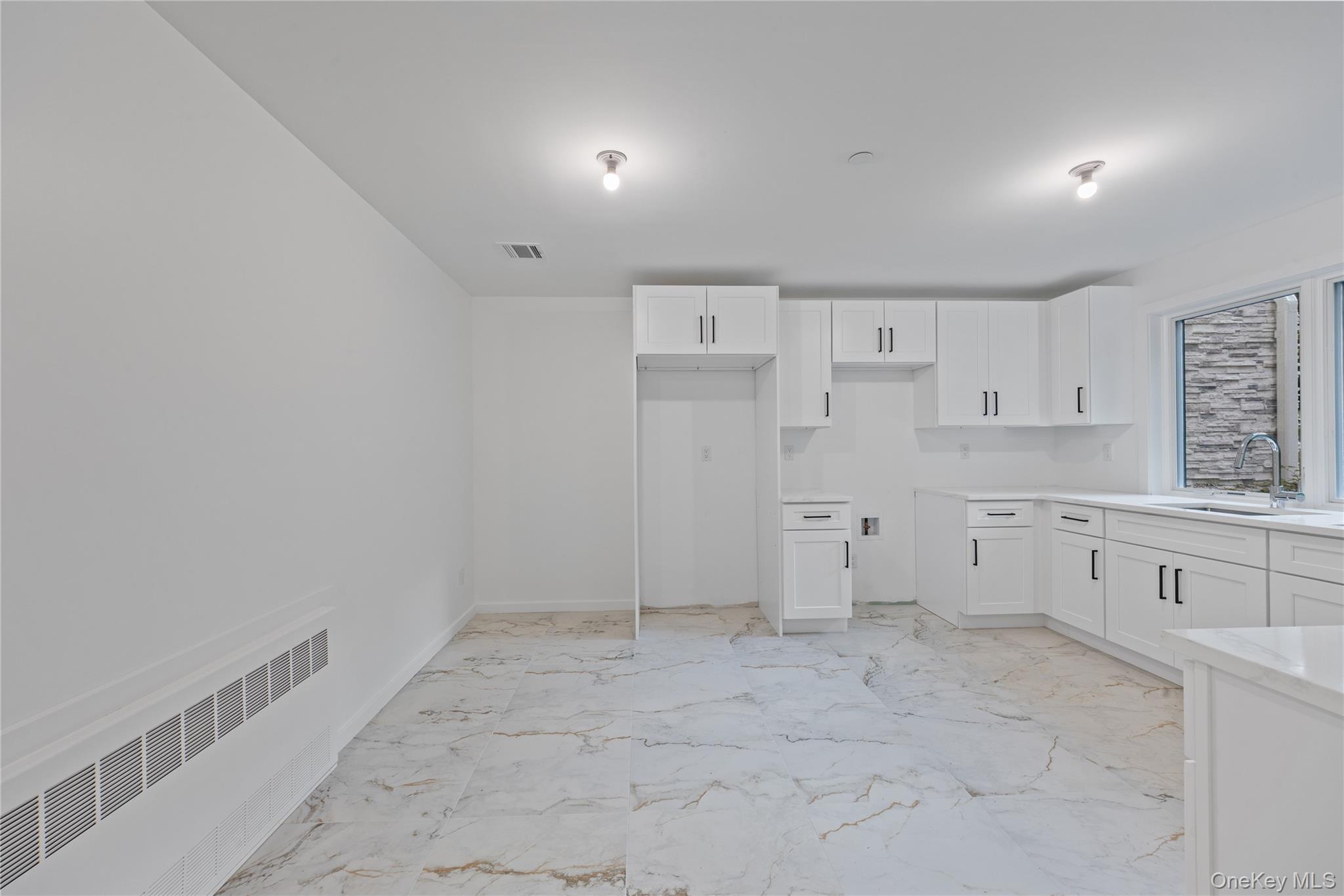 40 Singer Avenue, Unit 201 Spring Valley, NY 10977 - Photo 41 of 50 a view of a kitchen with white cabinets