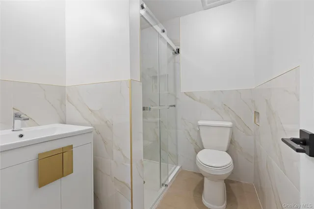 a bathroom with a toilet sink and shower