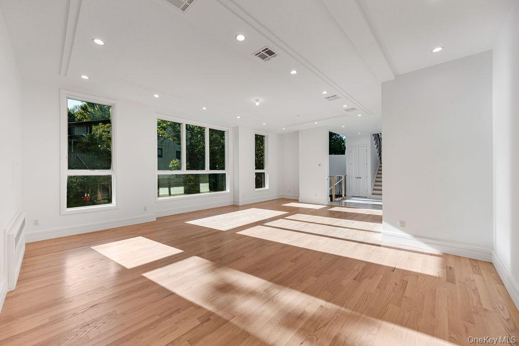 40 Singer Avenue, Unit 201 Spring Valley, NY 10977 - Photo 6 of 50 a view of an empty room with wooden floor and a window