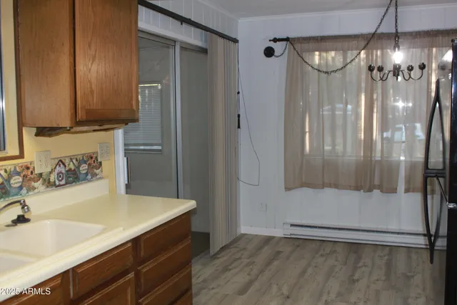 an empty room with wooden floor and a fireplace
