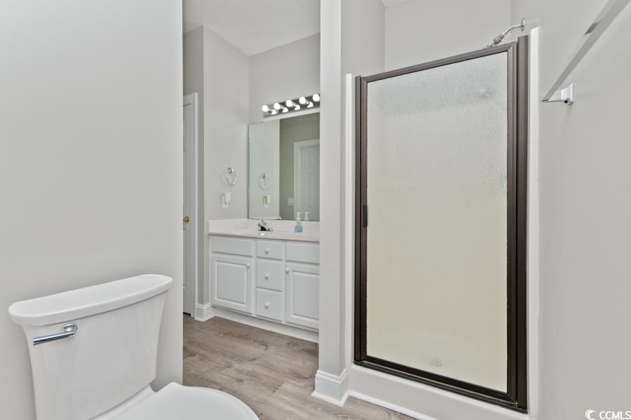 110 Cart Crossing Drive, Unit 102 Conway, SC 29526 - Photo 23 of 39 Full bath with a stall shower, light wood finished floors, and vanity
