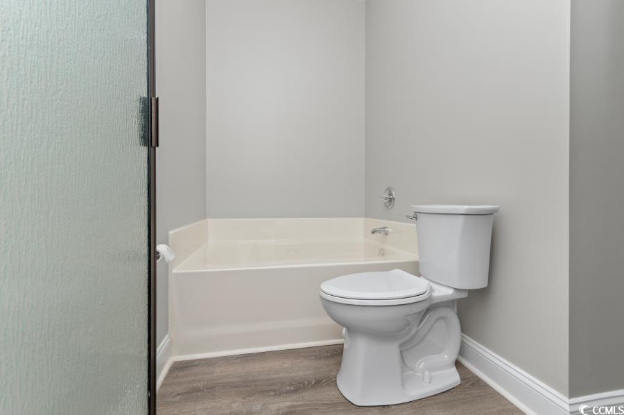 110 Cart Crossing Drive, Unit 102 Conway, SC 29526 - Photo 25 of 39 Bathroom featuring a bath and wood finished floors
