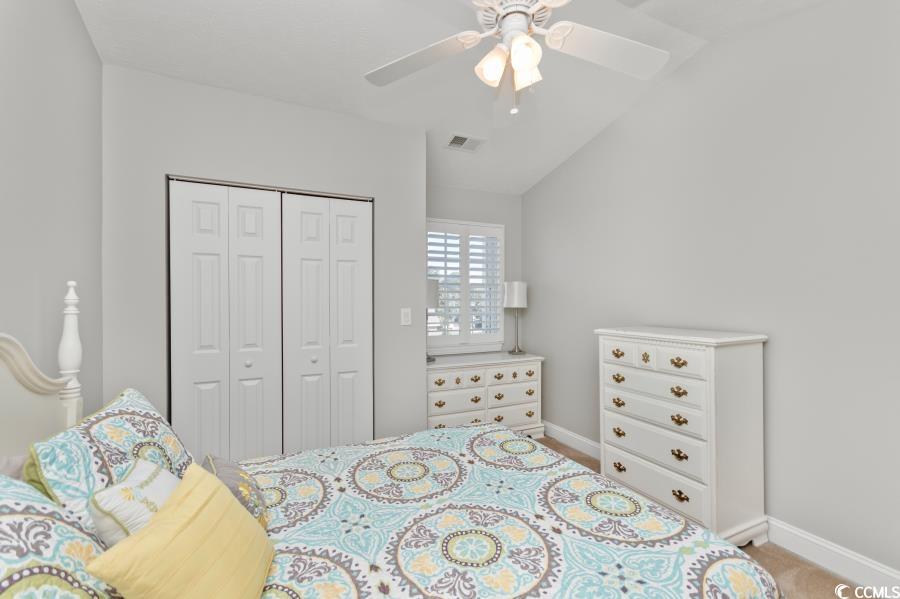110 Cart Crossing Drive, Unit 102 Conway, SC 29526 - Photo 30 of 39 Upstairs Bedroom with ceiling fan, a closet, lofted ceiling, and light carpet