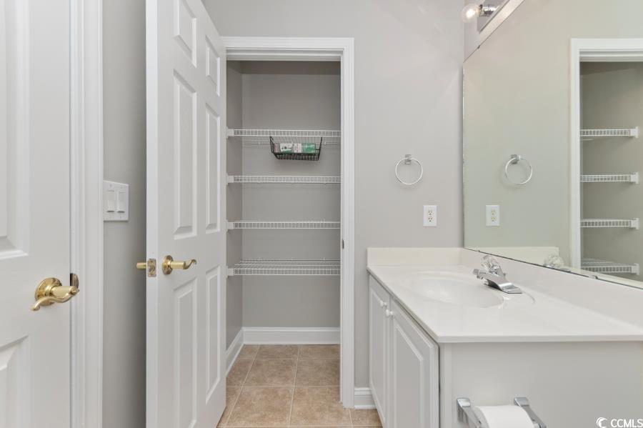 110 Cart Crossing Drive, Unit 102 Conway, SC 29526 - Photo 32 of 39 Upstairs Bathroom featuring vanity, light tile patterned floors, and a walk in closet