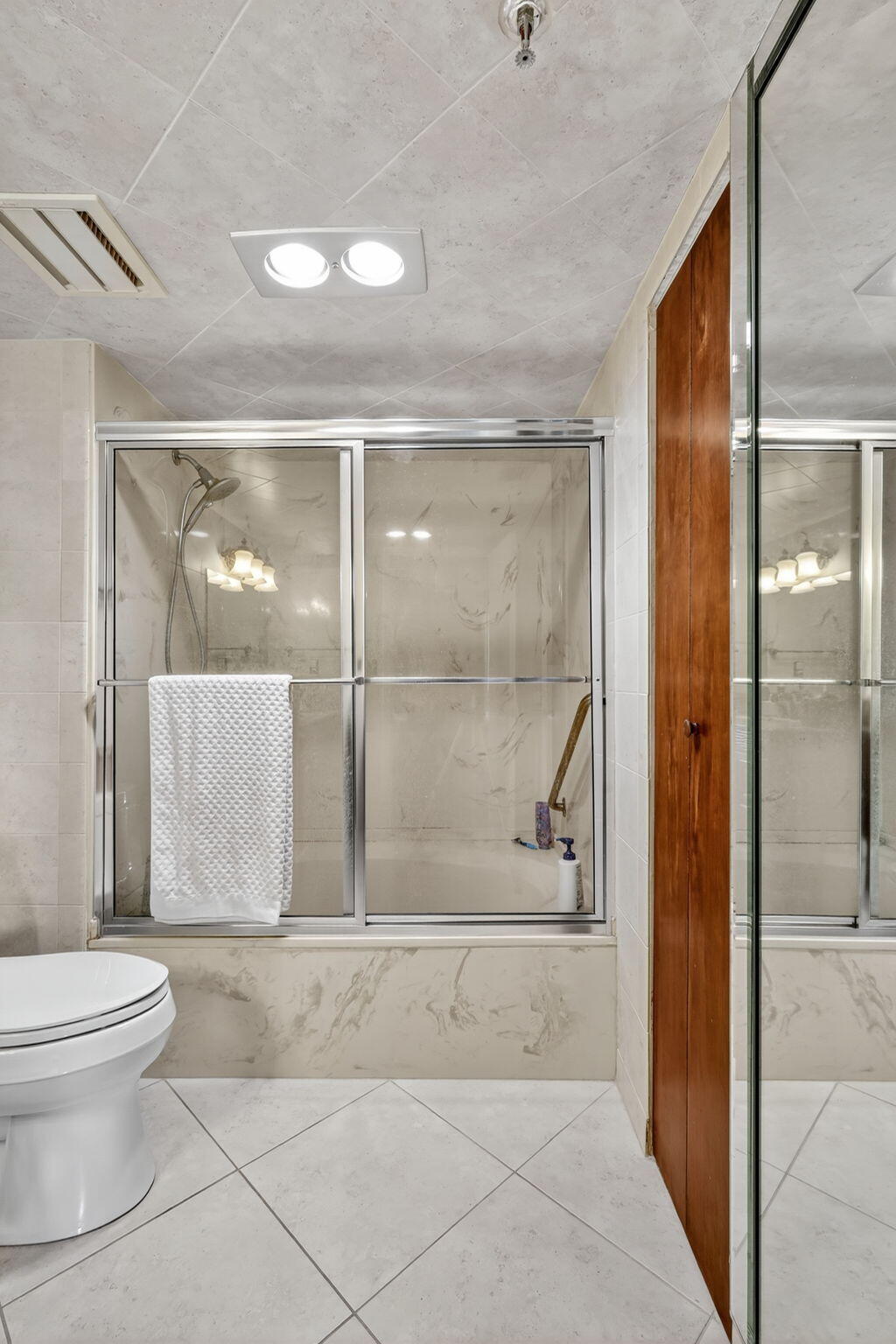 5340 Northwest 2nd Avenue, Unit 421 Boca Raton, FL 33487 - Photo 28 of 54 a bathroom with a glass shower door