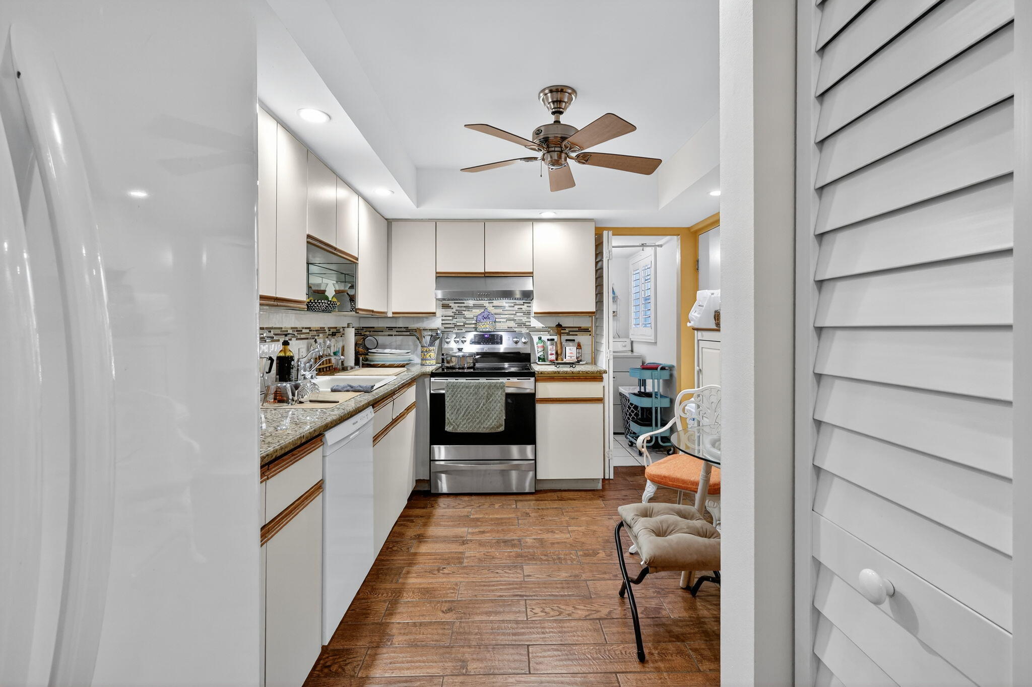 5340 Northwest 2nd Avenue, Unit 421 Boca Raton, FL 33487 - Photo 3 of 54 a kitchen with white cabinets and appliances
