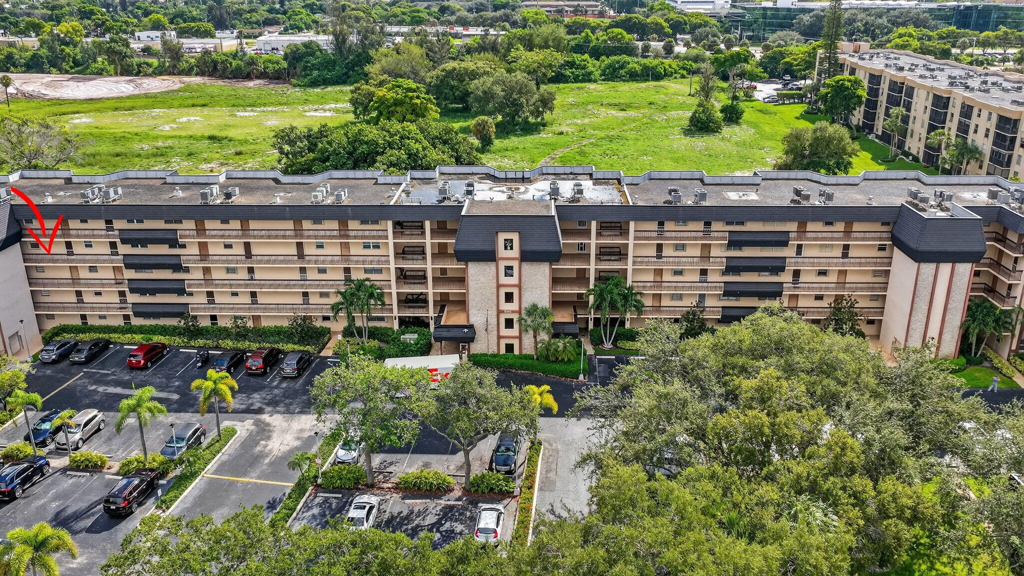 5340 Northwest 2nd Avenue, Unit 421 Boca Raton, FL 33487 - Photo 40 of 54 a view of a building with a garden and outdoor seating