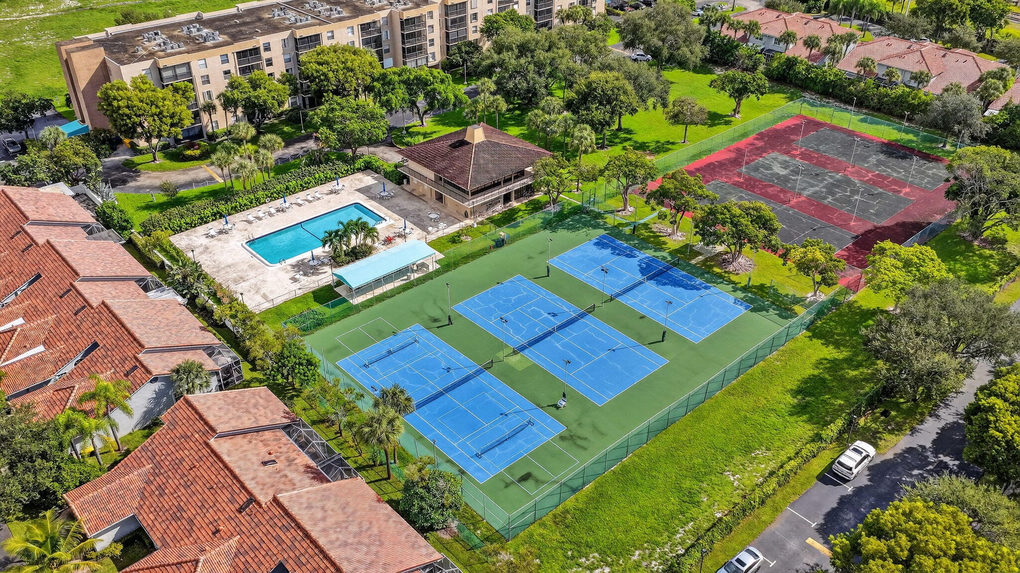 5340 Northwest 2nd Avenue, Unit 421 Boca Raton, FL 33487 - Photo 45 of 54 an aerial view of a tennis ground and a yard