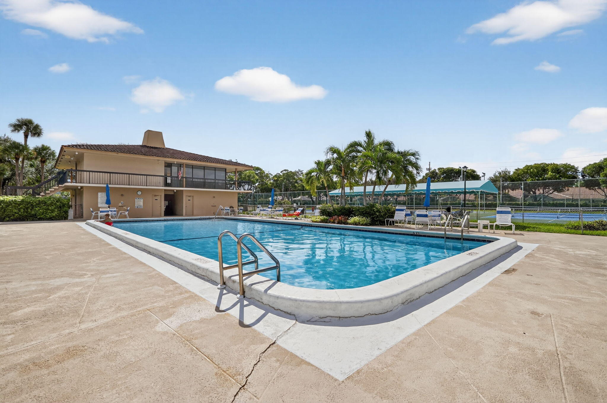 5340 Northwest 2nd Avenue, Unit 421 Boca Raton, FL 33487 - Photo 47 of 54 a view of a swimming pool with a chair and tables