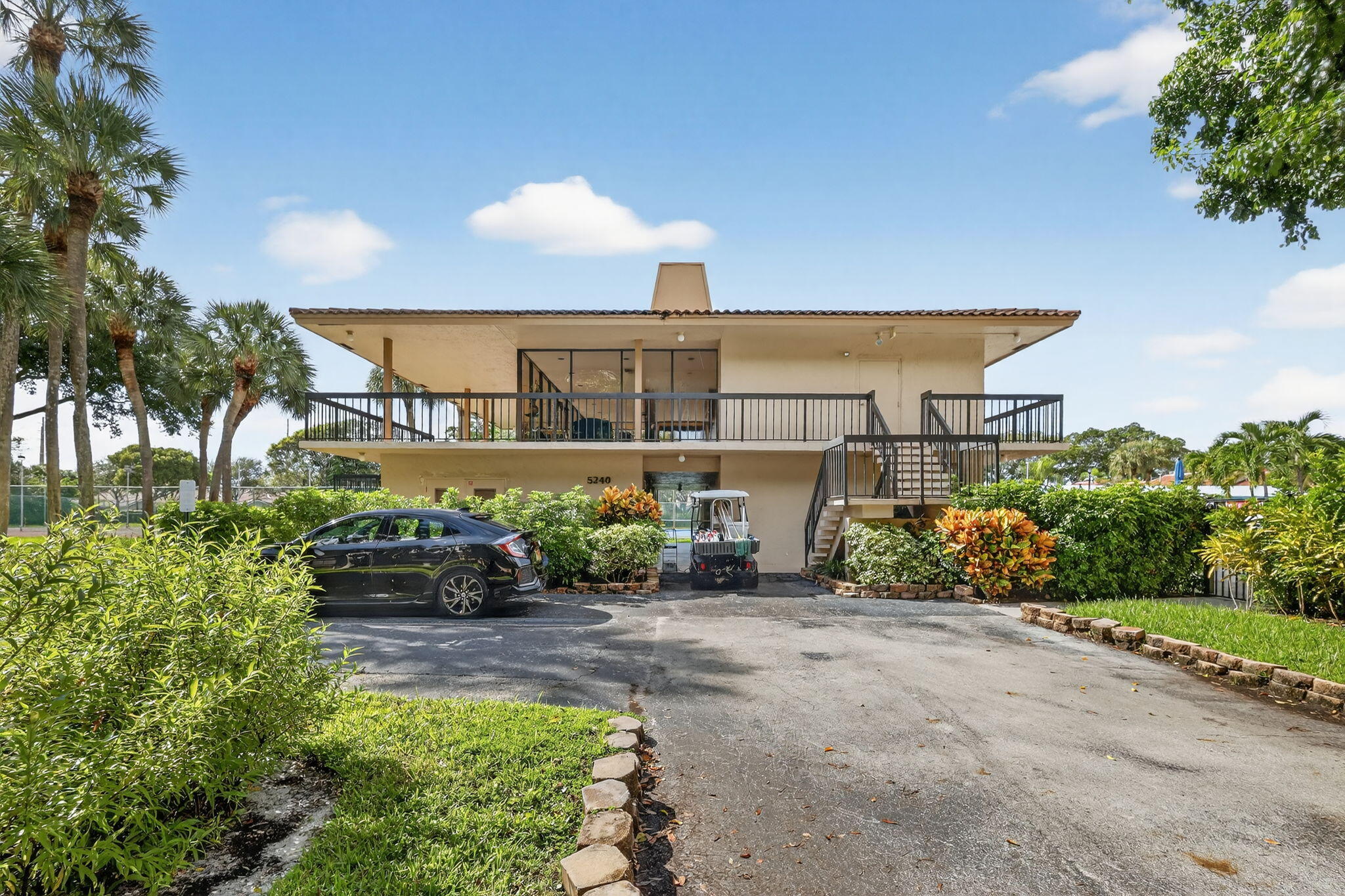 5340 Northwest 2nd Avenue, Unit 421 Boca Raton, FL 33487 - Photo 49 of 54 a view of a house with a yard and potted plants