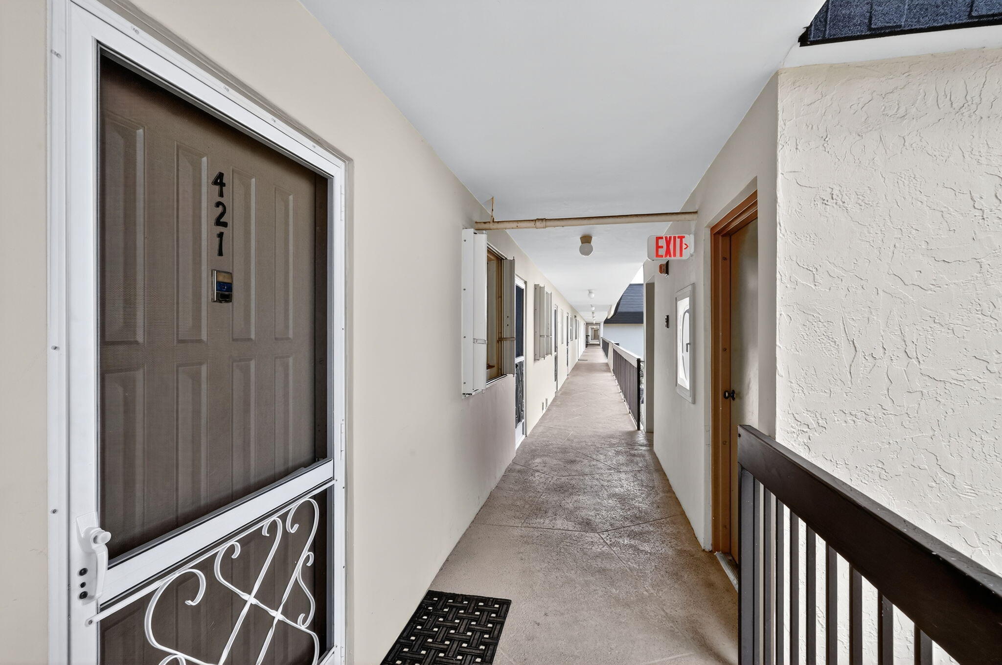 5340 Northwest 2nd Avenue, Unit 421 Boca Raton, FL 33487 - Photo 54 of 54 a view of a hallway with wooden staircase