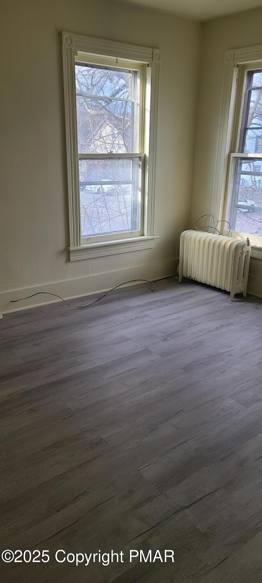 722 Monroe Street Stroudsburg, PA 18360 - Photo 5 of 11 an empty room with wooden floor and windows