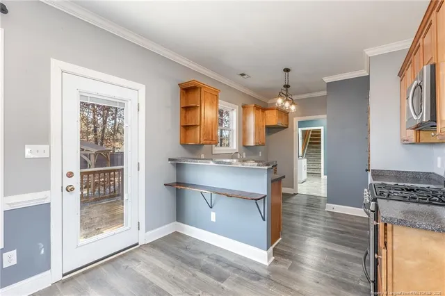 a kitchen with stainless steel appliances granite countertop a stove and a refrigerator