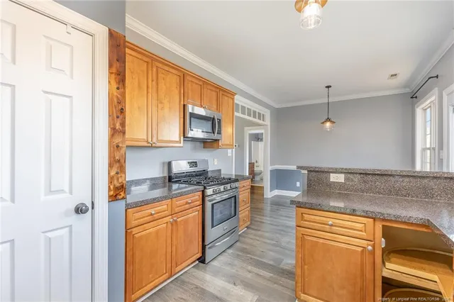 a kitchen with stainless steel appliances granite countertop a sink and cabinets