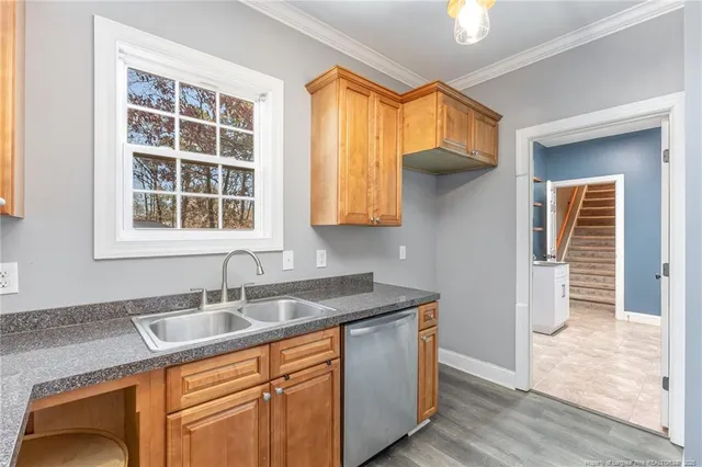 a kitchen with stainless steel appliances granite countertop a sink a stove and a refrigerator