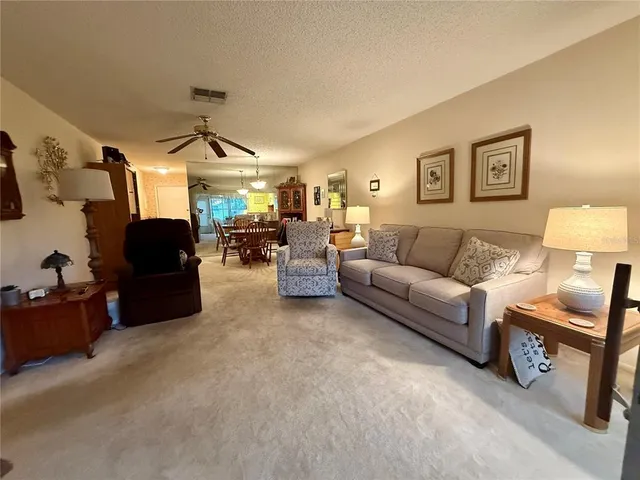 a living room with furniture a lamp and a chandelier