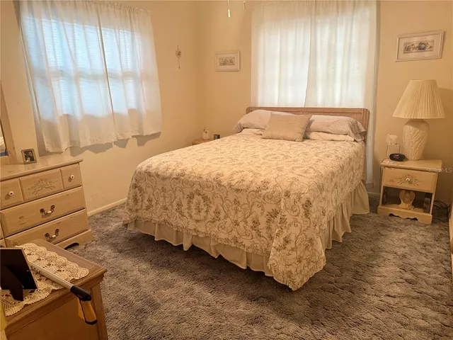 a bedroom with a bed and a chair