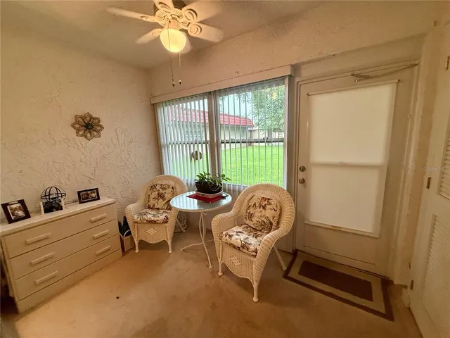 a living room with furniture a chandelier and a window