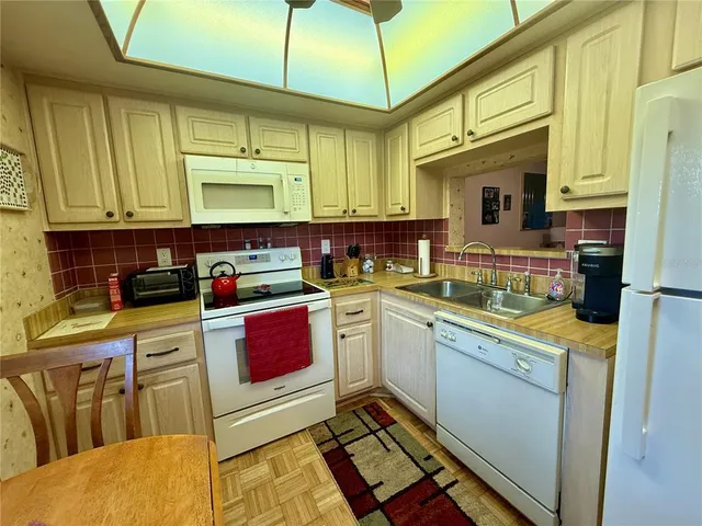 a kitchen with stainless steel appliances granite countertop a sink and cabinets
