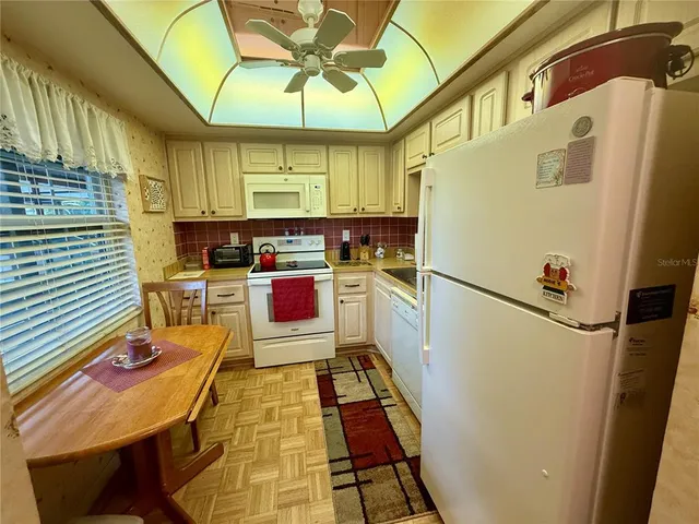 a kitchen with a refrigerator and a table