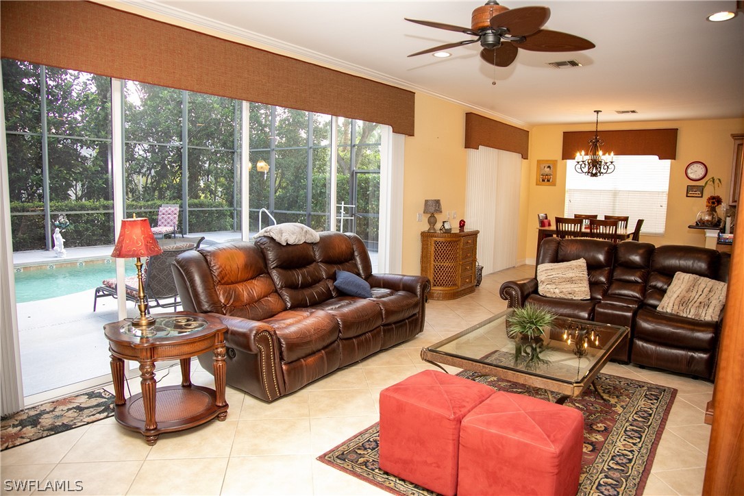 4345 Mistlethrush Lane Naples, FL 34119 - Photo 11 of 29 a living room with furniture and a large window