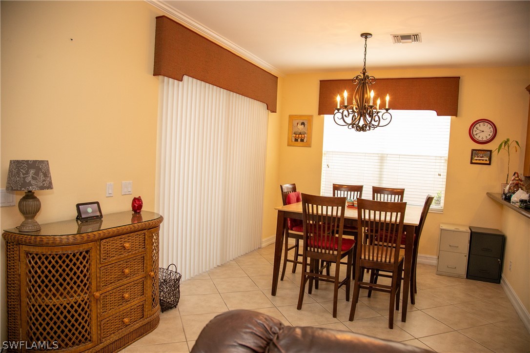 4345 Mistlethrush Lane Naples, FL 34119 - Photo 13 of 29 a view of a dining room with furniture
