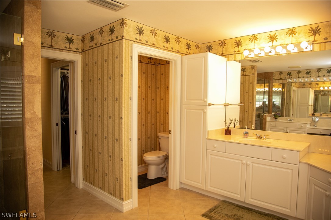 4345 Mistlethrush Lane Naples, FL 34119 - Photo 24 of 29 a bathroom with a shower and a sink