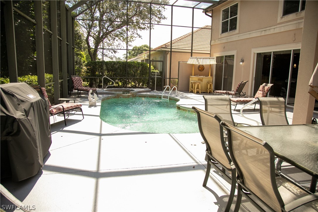 4345 Mistlethrush Lane Naples, FL 34119 - Photo 4 of 29 a view of a patio with couches table and chairs and potted plants