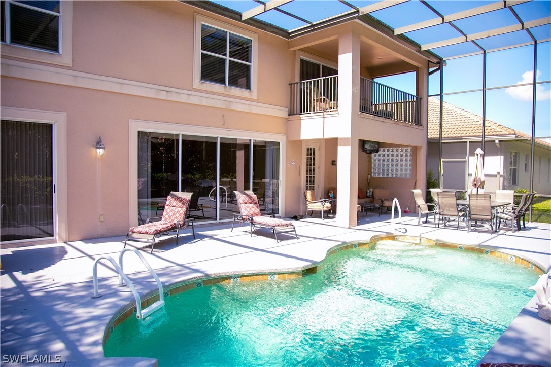 4345 Mistlethrush Lane Naples, FL 34119 - Photo 6 of 29 a view of a patio with table and chairs and potted plants