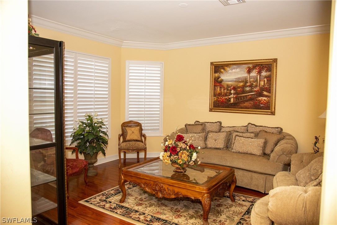 4345 Mistlethrush Lane Naples, FL 34119 - Photo 8 of 29 a living room with furniture and a potted plant