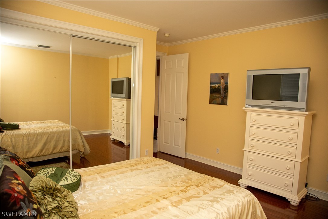 4345 Mistlethrush Lane Naples, FL 34119 - Photo 9 of 29 a bedroom with a bed and furniture