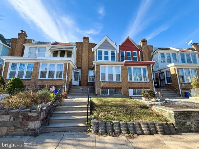 a front view of a residential apartment building with a yard