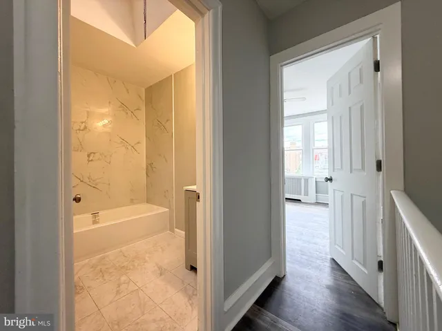 a bathroom with a tub and shower