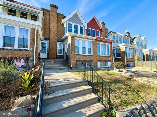a front view of a residential apartment building with a yard