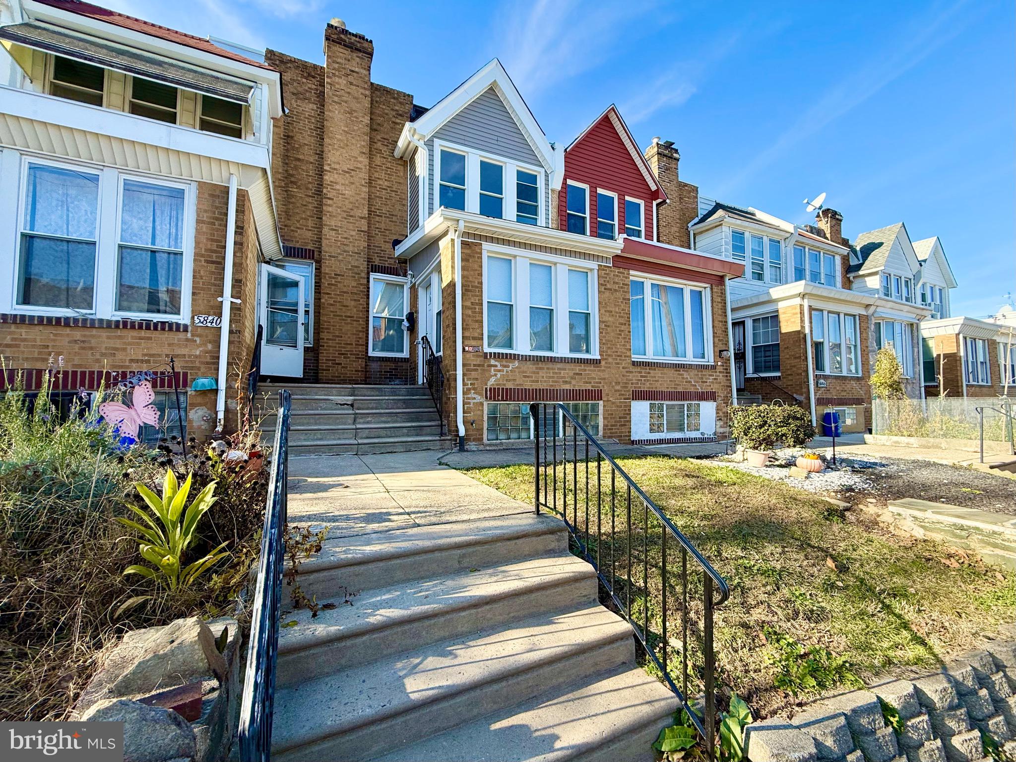 5842 North Hope Street Philadelphia, PA 19120 - Photo 3 of 45 a front view of a residential apartment building with a yard