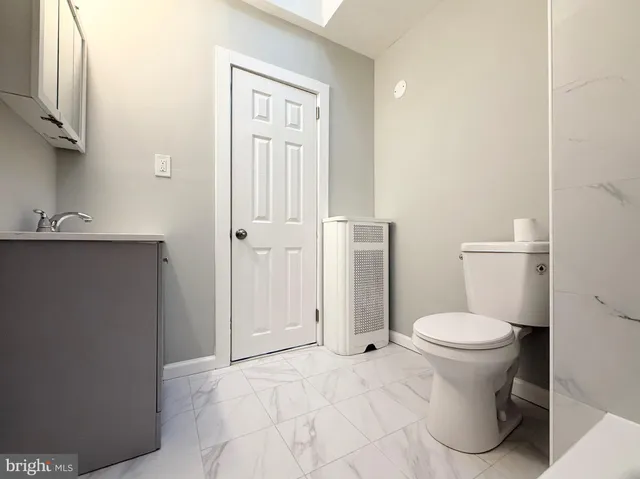 a bathroom with a toilet and a sink