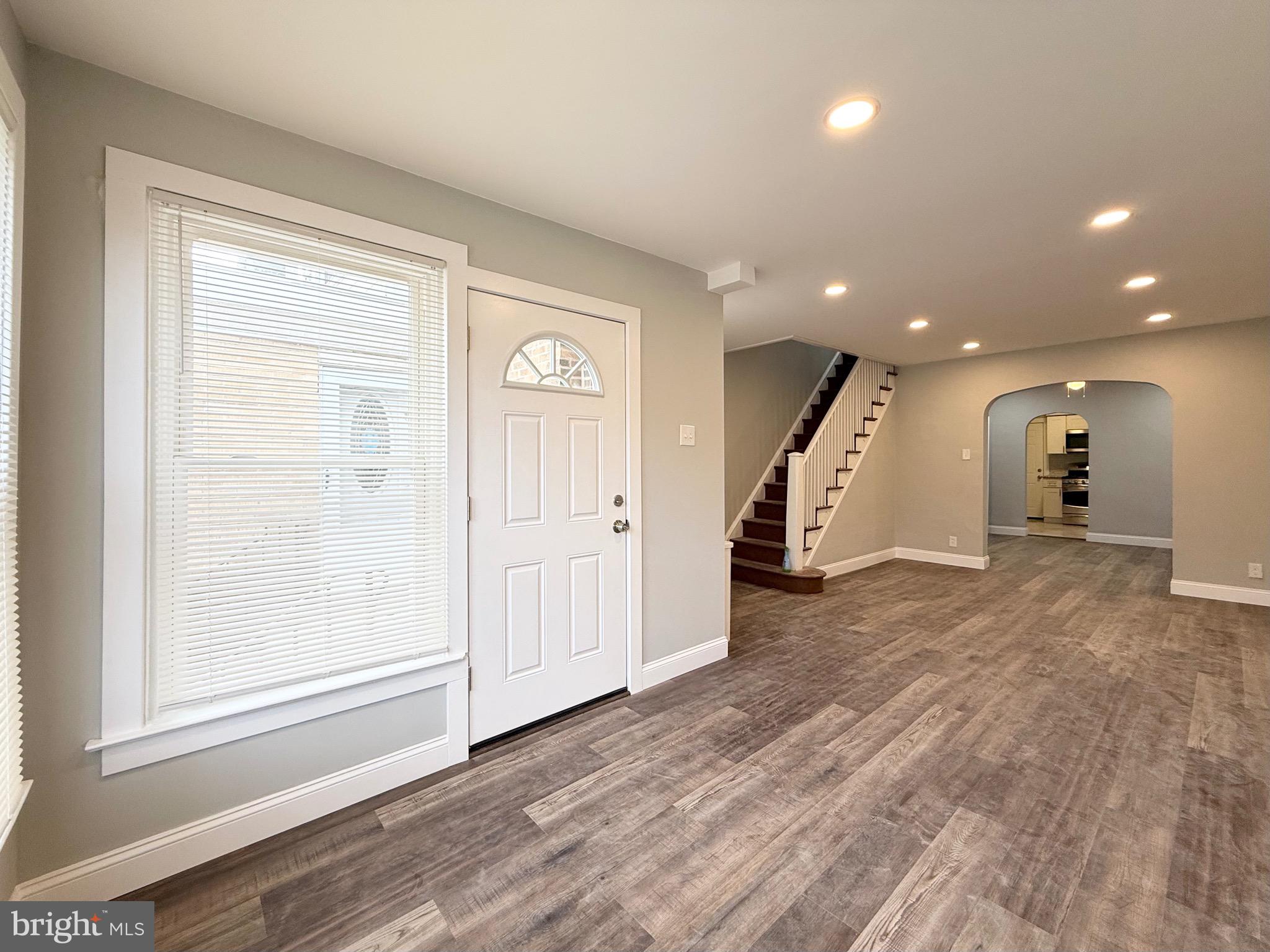 5842 North Hope Street Philadelphia, PA 19120 - Photo 7 of 45 a view of a hallway with wooden floor and staircase
