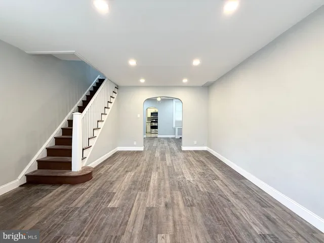 an entryway in wooden floor hall witha front door