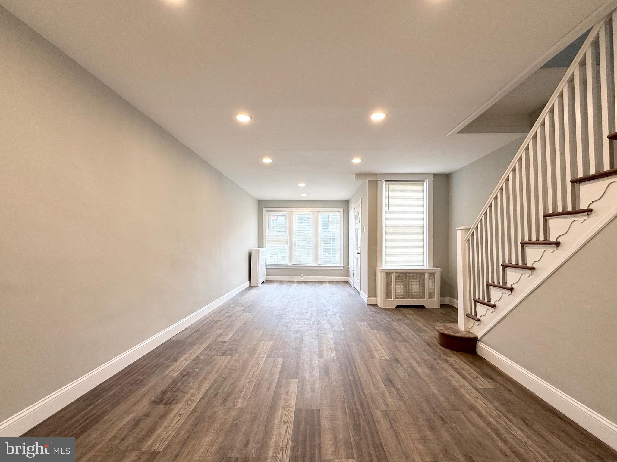 5842 North Hope Street Philadelphia, PA 19120 - Photo 10 of 45 a view of empty room with wooden floor and fan
