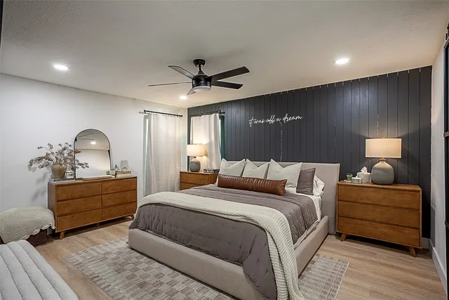 a bedroom with a bed and a chandelier