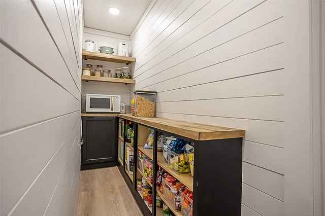 a view of a storage and utility room with washer and dryer