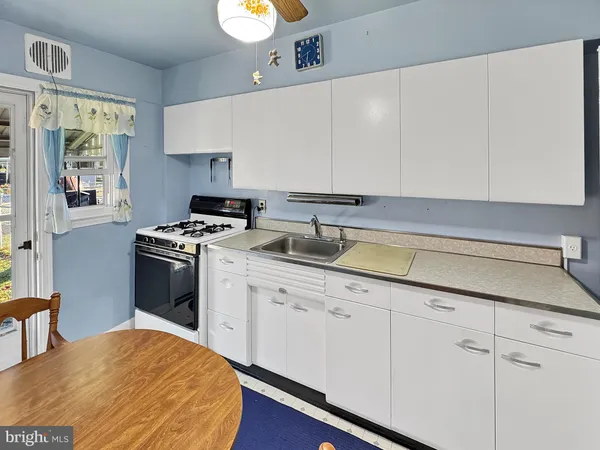 a kitchen with a sink cabinets and appliances
