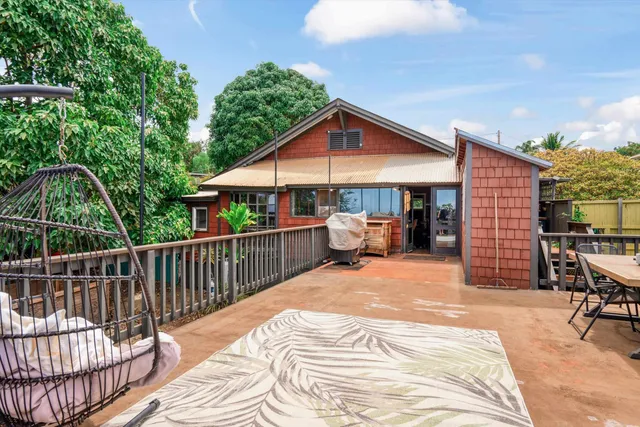a view of a chair and tables back yard of the house